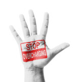 Stop overcharging written on a raised hand.