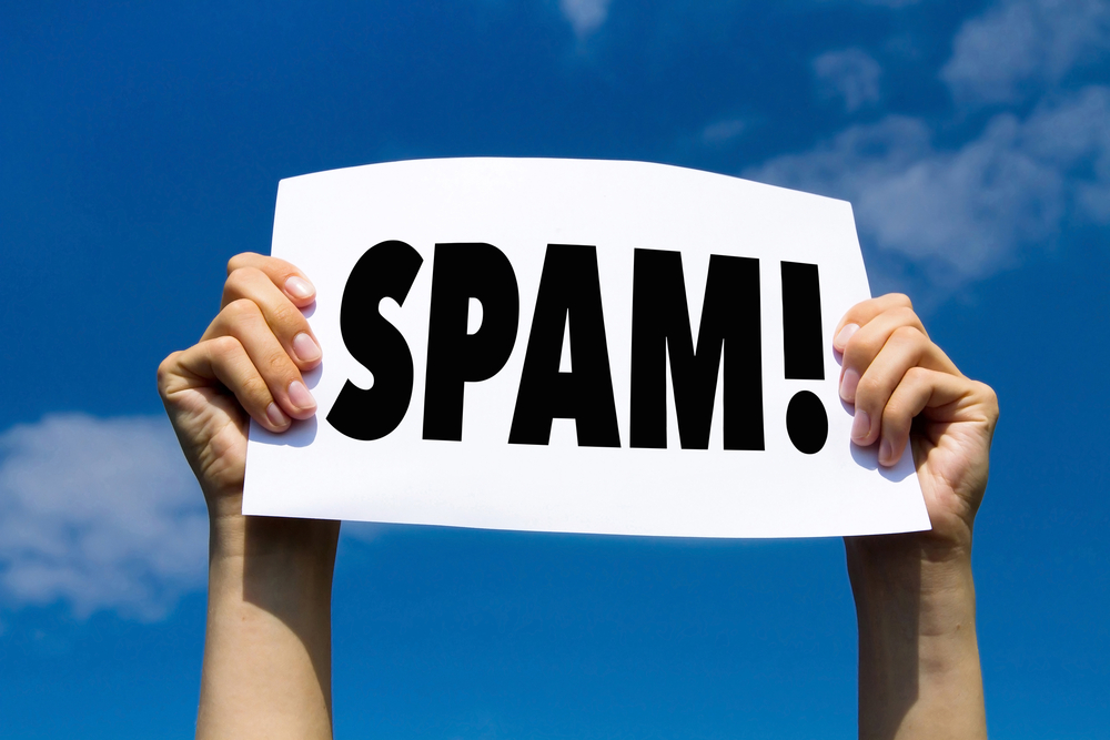 Person holding up a sign that says, "SPAM!"