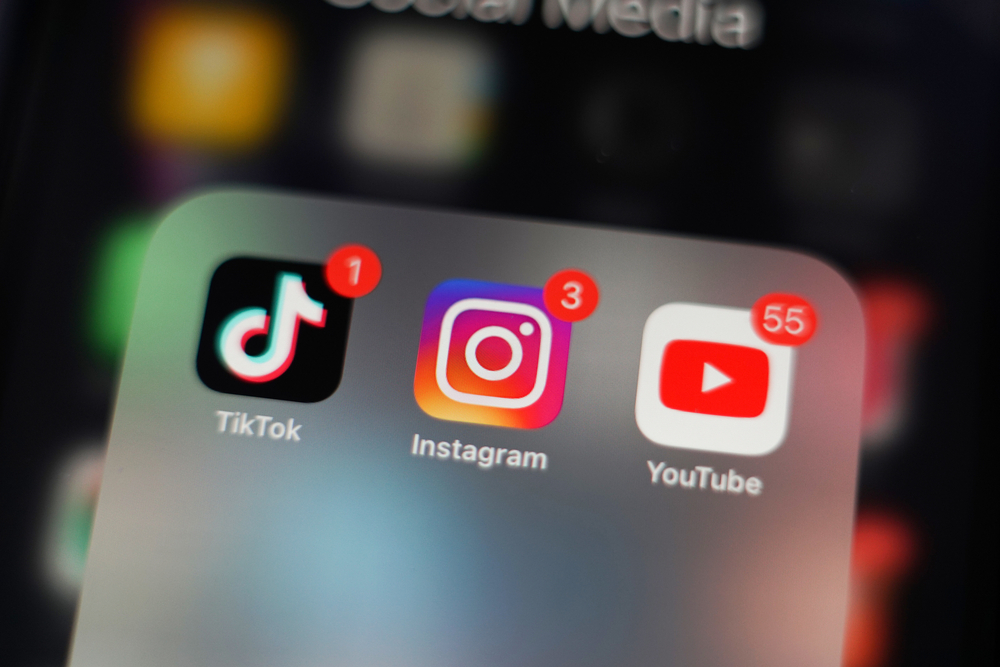 Screenshot of an iPhone homepage displaying a folder with TikTok, Instagram, and YouTube.