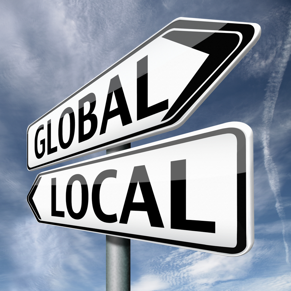 Global and Local written on a street signs, signifying the connection between payments and business