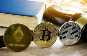 Cryptocurrency coins, Bitcoin, Ethereum, and Litecoin, standing in front of a gavel and book.