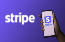 Stripe "S" logo on a mobile phone held by a hand on the right in front of a purple background with the word "Stripe" in white