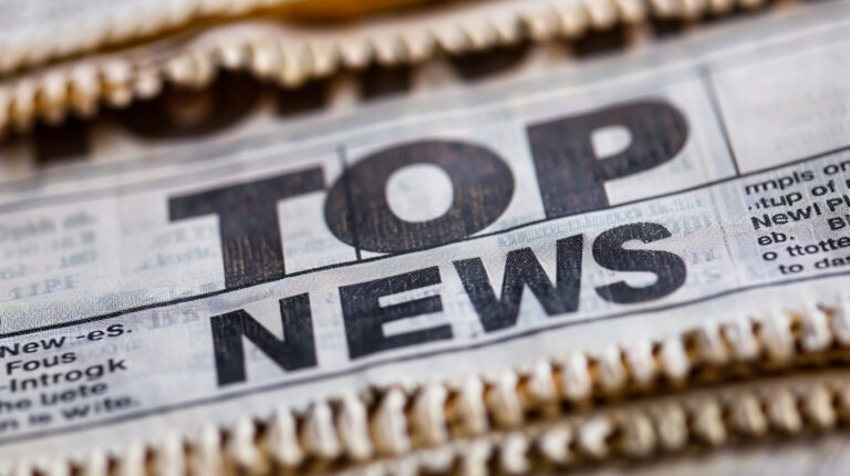 A newspaper headline that says "TOP NEWS"