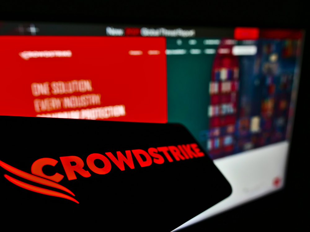 Crowdstrike Logo in front of a computer with blurred content