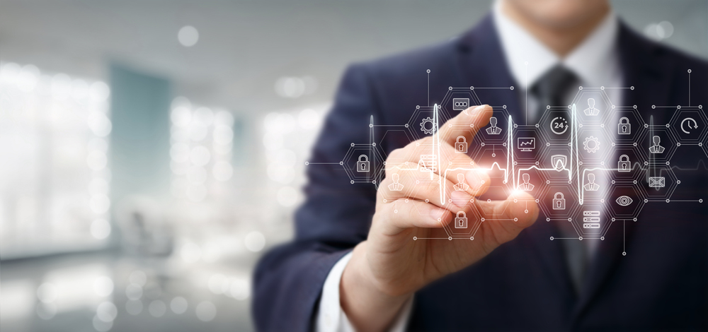 Man wearing a suit holding his finger toward an invisible screen with white icons