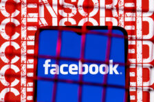 Facebook social network logo on the smartphone screen behind the bars on the background with the inscription censored. The concept of facebook censorship and prohibition.