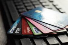 Selective focus on a group of credit and debit cards placed on a computer keyboard