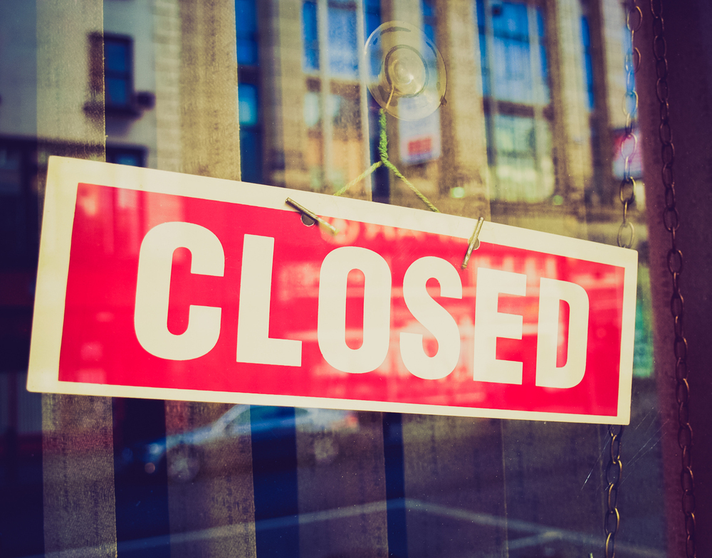 Vintage retro looking Closed sign in a shop showroom with reflections