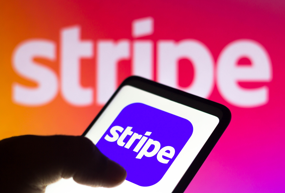 the Stripe logo seen displayed on a smartphone and on the background