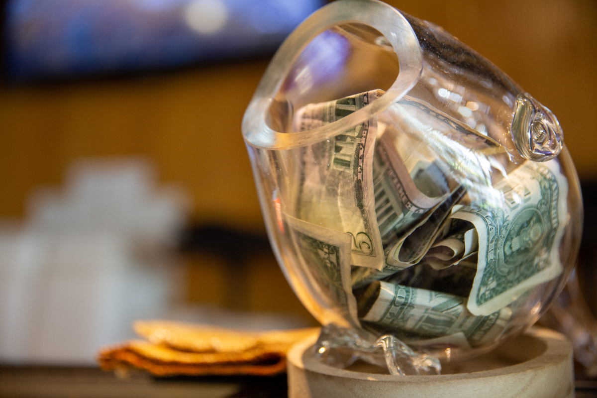 tip jar at a sushi bar with money