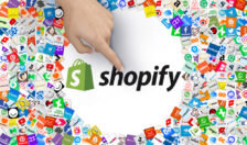 "Shopify" logo in a white circle surrounded by various icons and a finger pointing at it
