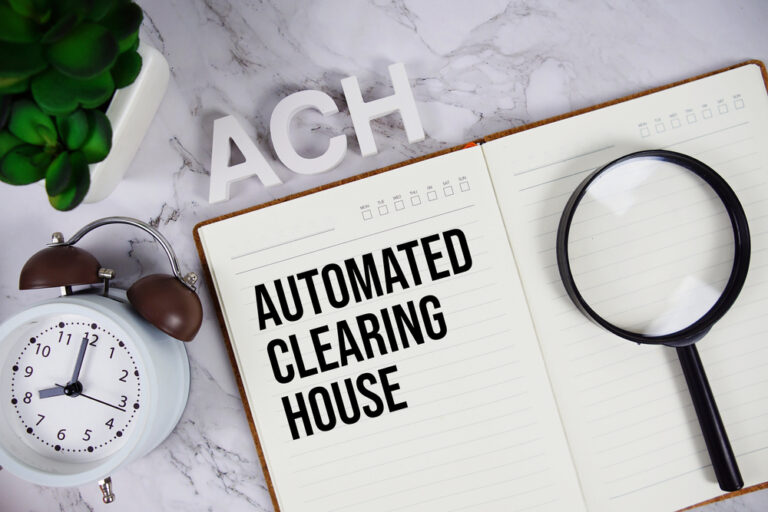 ACH - Automated Clearing House acronym on notepad, Business and Financial concept background