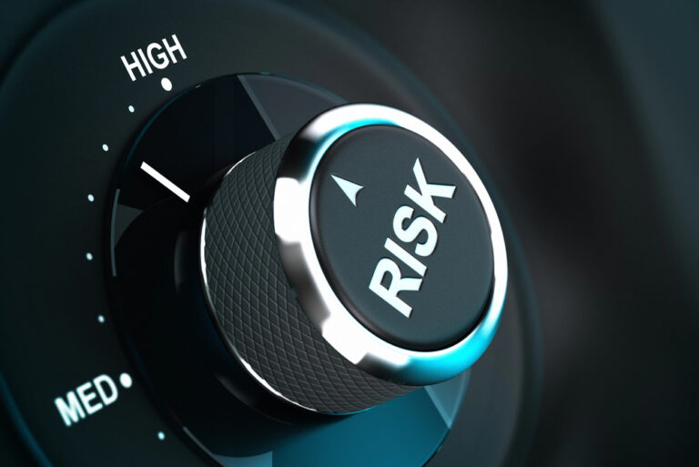Dial with the label “RISK” pointing at “HIGH”