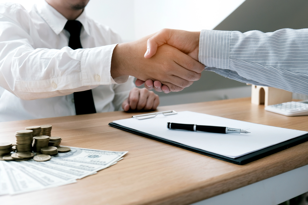 Business people signing contract making a deal