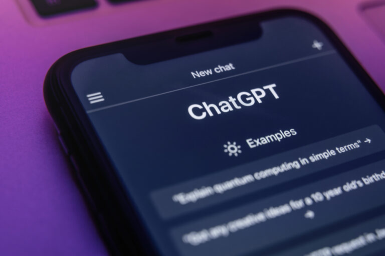 The ChatGPT chatbot on a mobile phone screen in neon light. ChatGPT language model utilizing Open AI's state-of-the-art technology, is accessible through any device.